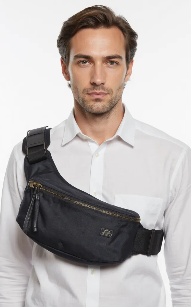 A French male model with a Hip pack, wearing a shirt, against a white background, in a front   facing close   up